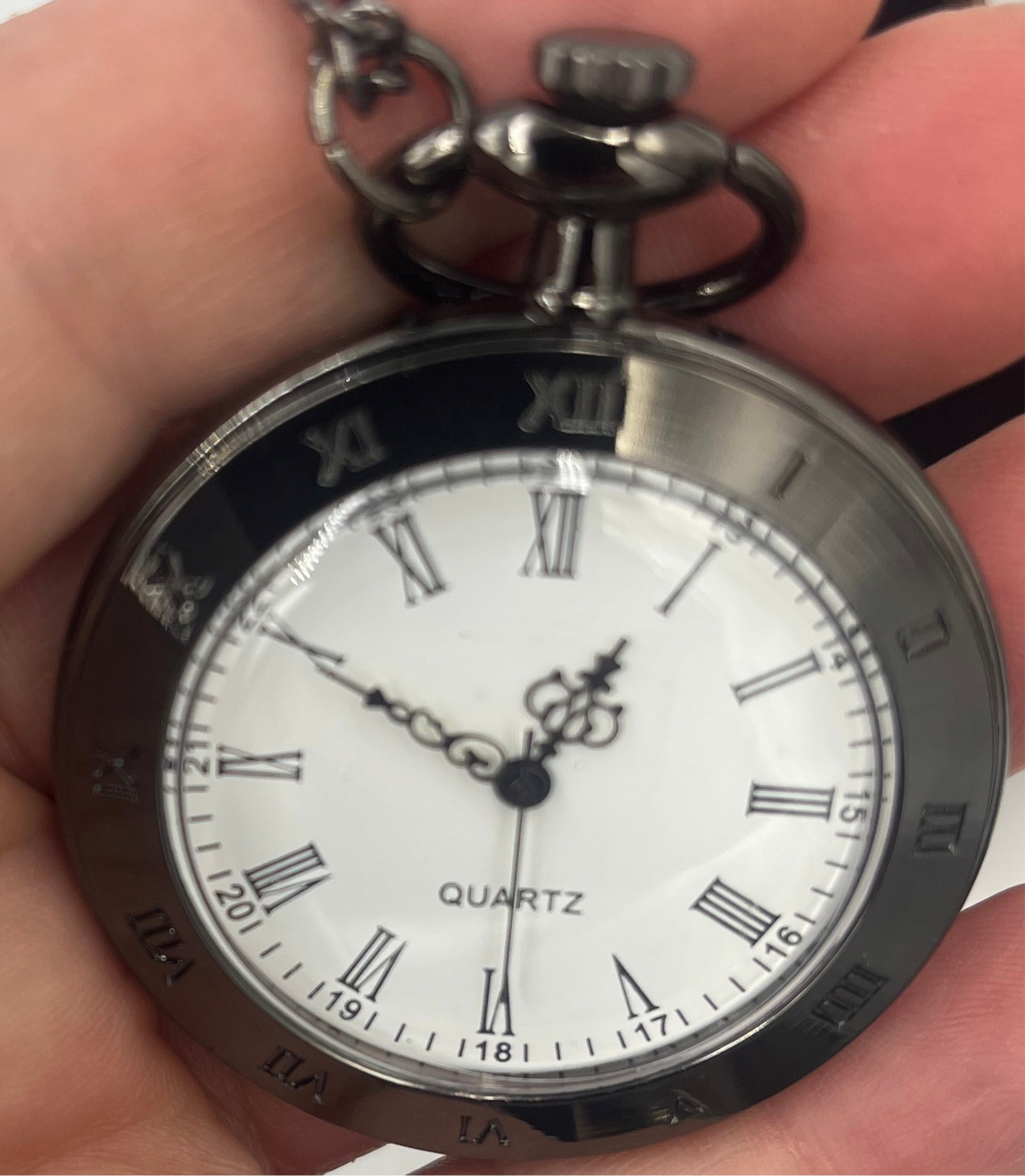 Black Vintage style pocket watch with Roman numerals.