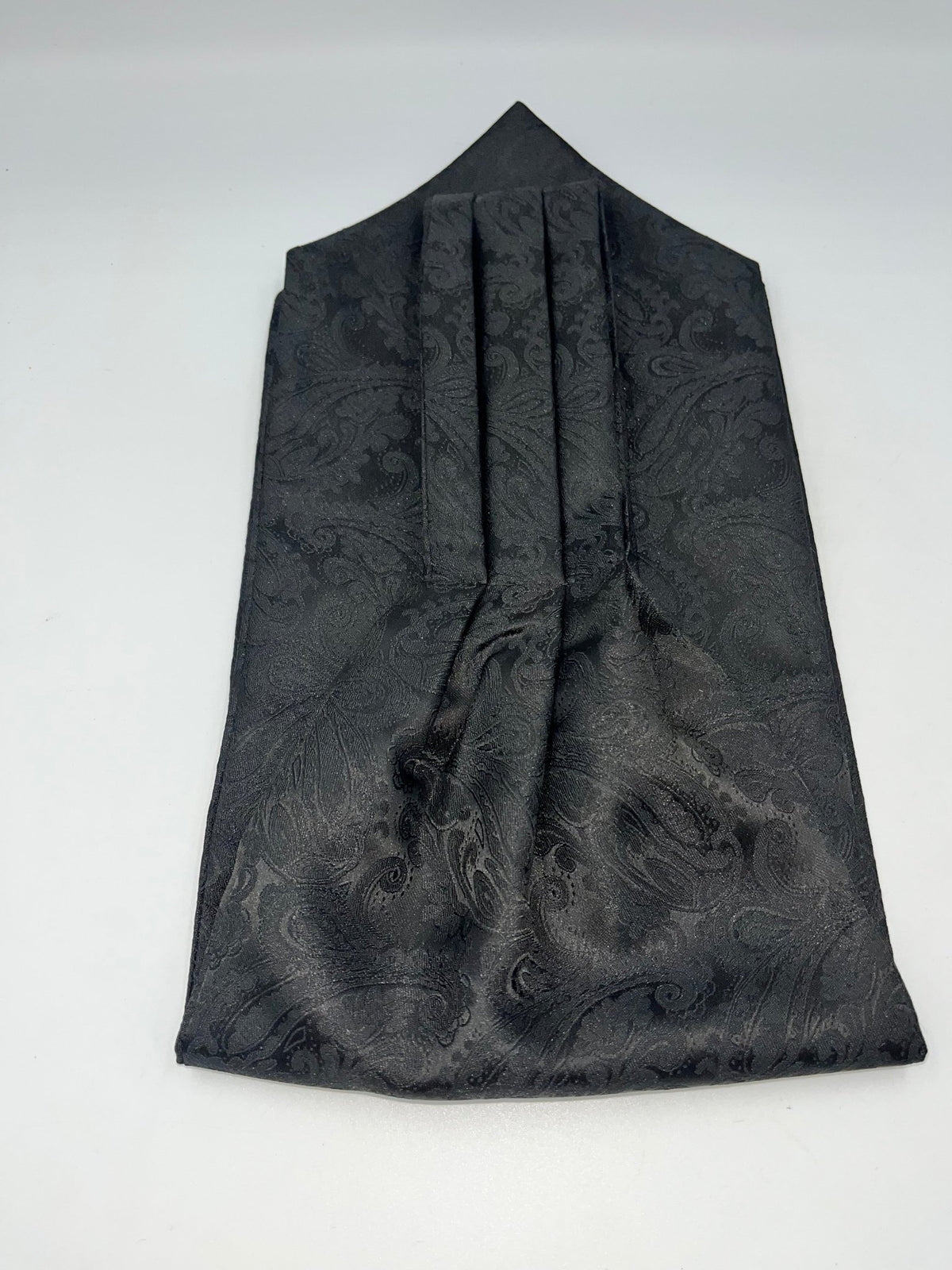 A black pleated silk cravat with a subtle woven paisley pattern, displayed for weddings and formal wear- SteampunkgearSa