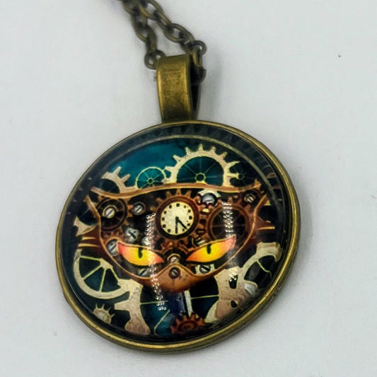 Round steampunk cat pendant with yellow eyes, gear details and a chain.